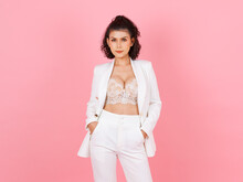Portrait Isolated Cutout Studio Shot Asian Sexy Curly Hairstyle Success Businesswoman In White Fashionable Casual Suit With Lace Lingerie Crop Top Bra Standing Posing On Pink Background.