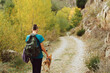 © ADDICTIVE STOCK - Crop woman with dog hiking in park