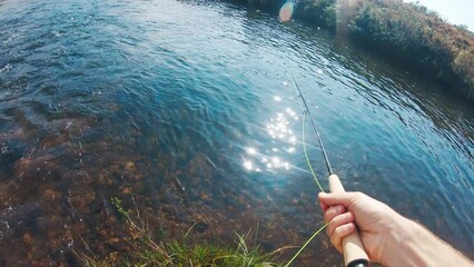 Wall Mural - Fishing cast POV. Man fly fishing on the rapid clear river and makes a cast