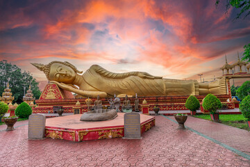 Wall Mural - A reclining Buddha statue at Wat Pha That Luang lacated in Vientiane, Laos.