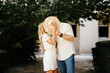 © ADDICTIVE STOCK - Couple covering faces with hat and kissing on street