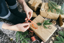 Closeup View Of Woman Hands Wrapping A Handmade Christmas Present
