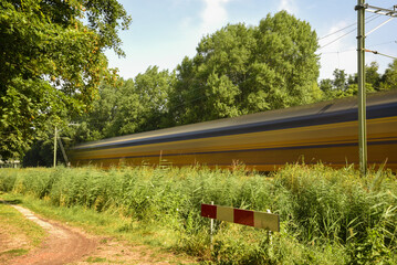 Wall Mural - Den Helder, Netherlands. August 2022. Long exposure shoot of passing train.