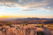 Dramatic golden sky sunset clouds over the grass fields and desert of Big Bend National Park Texas