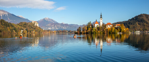 Wall Mural - Panoramic view of Lake Bled with St. Marys Church of the Assumption on the small island. Bled, Slovenia, Europe.