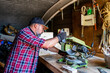 © ADDICTIVE STOCK - Focused male splitting wood with miter saw