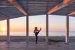 © ADDICTIVE STOCK - Flexible woman doing yoga at seaside during sunrise