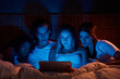 © ADDICTIVE STOCK - Scared flatmates watching horrors in dark bedroom