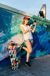 © ADDICTIVE STOCK - Skater woman using phone