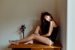 © ADDICTIVE STOCK - Charming Hispanic lady on table in room