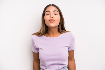 hispanic latin pretty woman pressing lips together with a cute, fun, happy, lovely expression, sending a kiss