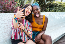 Positive Couple Of Multiethnic Lesbian Women Making Faces At Camera