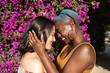 © ADDICTIVE STOCK - Multi ethnic lesbian couple hugging outdoors