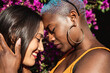 © ADDICTIVE STOCK - Multiethnic lesbian couple hugging outdoors