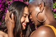 © ADDICTIVE STOCK - Multiethnic lesbian couple hugging outdoors