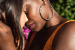 © ADDICTIVE STOCK - Multiethnic lesbian couple hugging outdoors