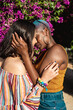 © ADDICTIVE STOCK - Multiethnic lesbian couple hugging outdoors