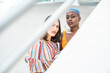 © ADDICTIVE STOCK - Stylish multiethnic couple of women in city