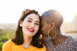 © ADDICTIVE STOCK - Multi ethnic lesbian couple hugging outdoors