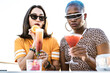 © ADDICTIVE STOCK - Multiethnic couple of cool lesbian women drinking cocktails