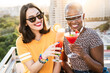 © ADDICTIVE STOCK - Multiethnic couple of cool lesbian women drinking cocktails