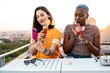 © ADDICTIVE STOCK - Lesbian couple taking selfie on balcony