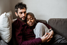 Young Multiethnic Couple Resting On Sofa