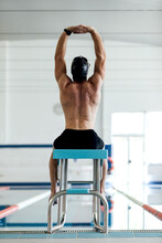Unrecognizable Muscular Sportsman Exercising On Block Against Pool