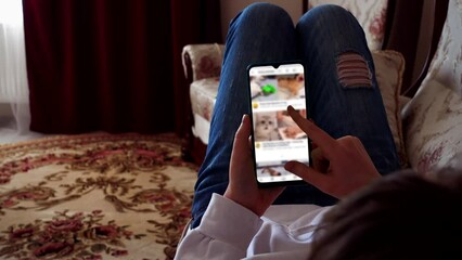 A teenager looks a feed with animals in social networks