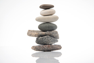 Wall Mural - pyramid of stacked stones on a white background. stabilization and balance in life