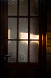 © Horacio Selva - Old door with frosted glass illuminated by the sun.