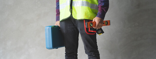 Wall Mural - Repairman standing in the room and holding toolbox.