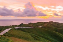 Walkway On The Green Hills Under The Pink Sunset Sky In Batanes