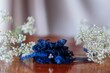 Closeup shot of a blue wedding bridal wrist corsage on a table