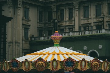 Wall Mural - Roof of a carousel against an old building