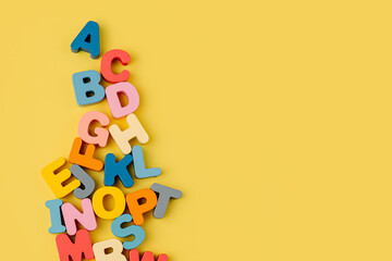 colorful letters of the alphabet on yellow background. primary school or preschool, kindergarten. ed