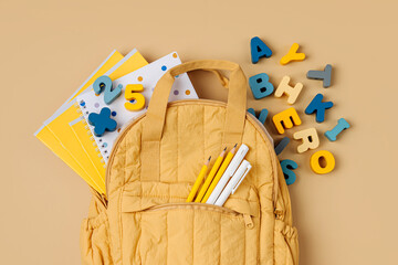 Wall Mural - Opened School backpack with stationery. Primary school or preschool, kindergarten. Kids Backpack on beige background.