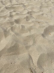 Sticker - Golden sand beach texture with foot steps on a sunny day