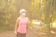 © Angelov - Pandemic coronavirus COVID-19 A woman in a meadow in a sports outfit wearing a protective mask in case of the spread of SARS-CoV-2 disease virus. Girl with a protective mask on her face.