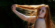 © ullision - Portrait of young sexy seductive beautiful woman redhead ginger with red hair, backlight showing her beautiful hair, against dark background