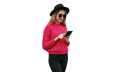 Wall Mural - Portrait of young woman with smartphone wearing pink knitted sweater and black round hat isolated on white background