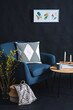 © Syda Productions - interior and home decor concept - close up of blue chair, coffee table and blanket in basket in dark room