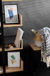 © Syda Productions - interior and home decor concept - book shelf with art and decorations over black background