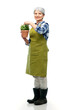 © Syda Productions - gardening, farming and old people concept - portrait of smiling senior woman in green garden apron with flower in pot over white background