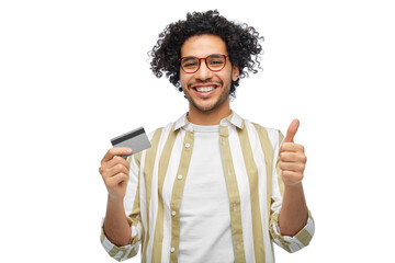 Wall Mural - shopping, finance and people concept - happy smiling man with credit card showing thumbs up over white background