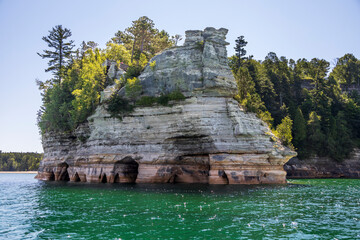 Wall Mural - Colorful stone rocks on the edge of a lake in the summer