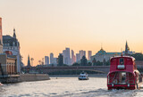 Fototapeta Londyn - River trams ships on the Moskva river against the backdrop of sunset and Moscow City.