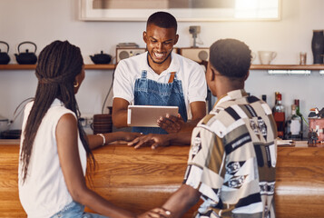 Poster - Hospitality, service and technology with restaurant worker taking orders on a digital tablet, smiling and talking. Young employee manage customer payment on an online app, paying using the internet