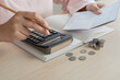 © StockerThings - Woman doing home accounting calculating book bank statement for household expense