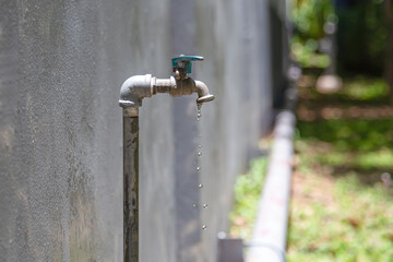 Wall Mural - Old faucet outside the house dripping